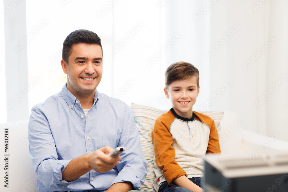 smiling father and son watching tv at home smiling father and son watching tv at home