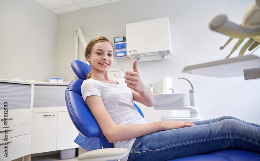 happy patient girl showing thumbs up at clinic happy patient girl showing thumbs up at clinic