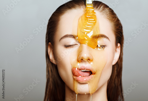 Woman with honey on her face. Healthy perfect skin. Honey treatment