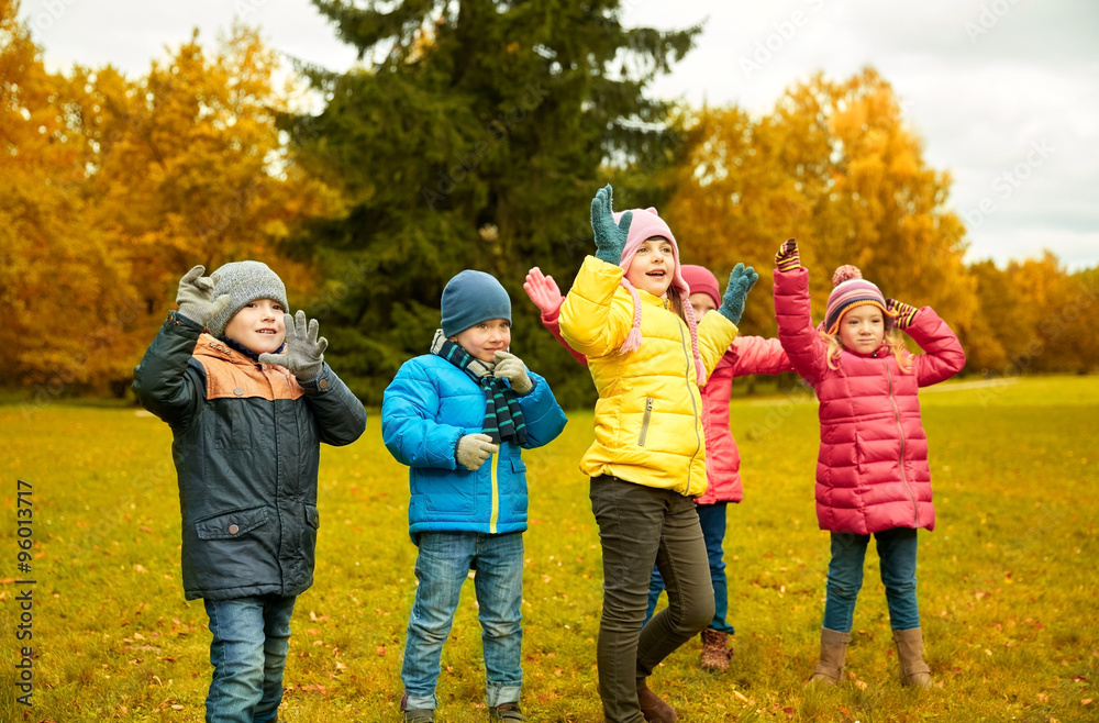 group of happy children having fun in autumn park group of happy children having fun in autumn park