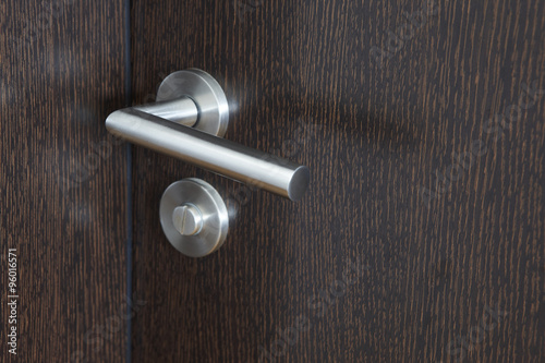 Quadro em tela Metallic door knob with lock over a wengue wooden door