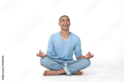 Young man in casual sitting in the lotus position over white background