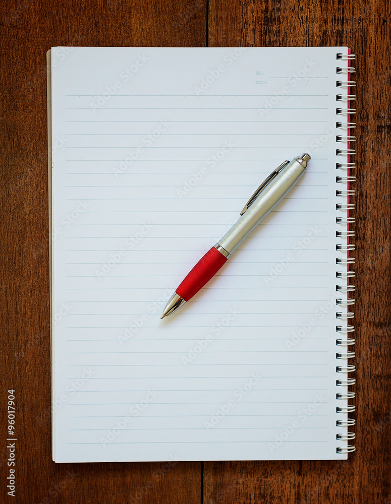 Notebook and pen on wooden background Notebook and pen on wooden background