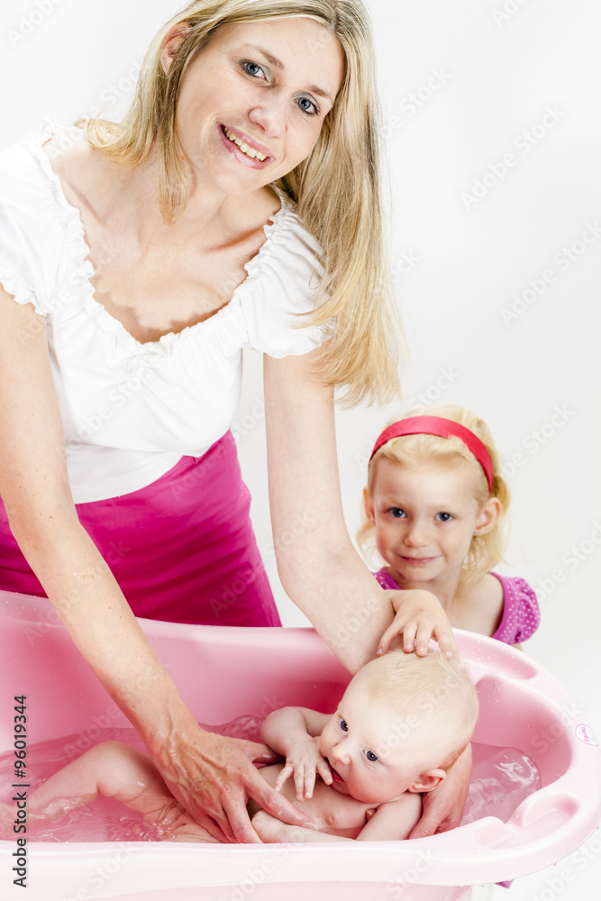 portrait of mother with her baby and daughter during bathing portrait of mother with her baby and daughter during bathing