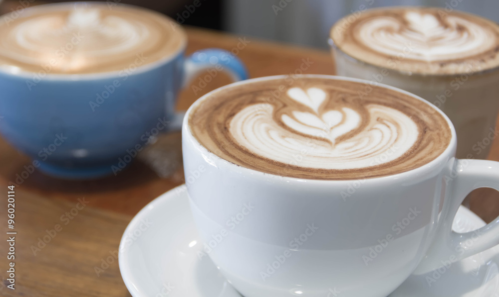 Close up white cup of Coffee, latte on the wooden table Close up white cup of Coffee, latte on the wooden table