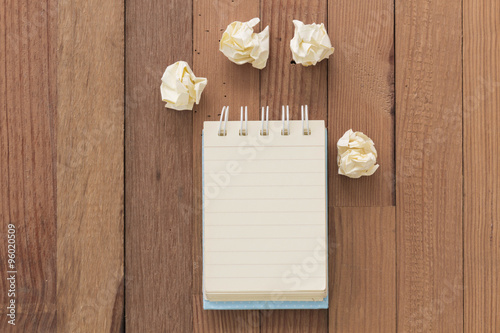 Little note book on textured wooden background