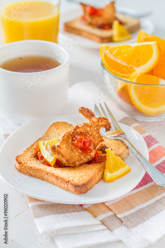 Bunny shaped toast with jam, juice and tea