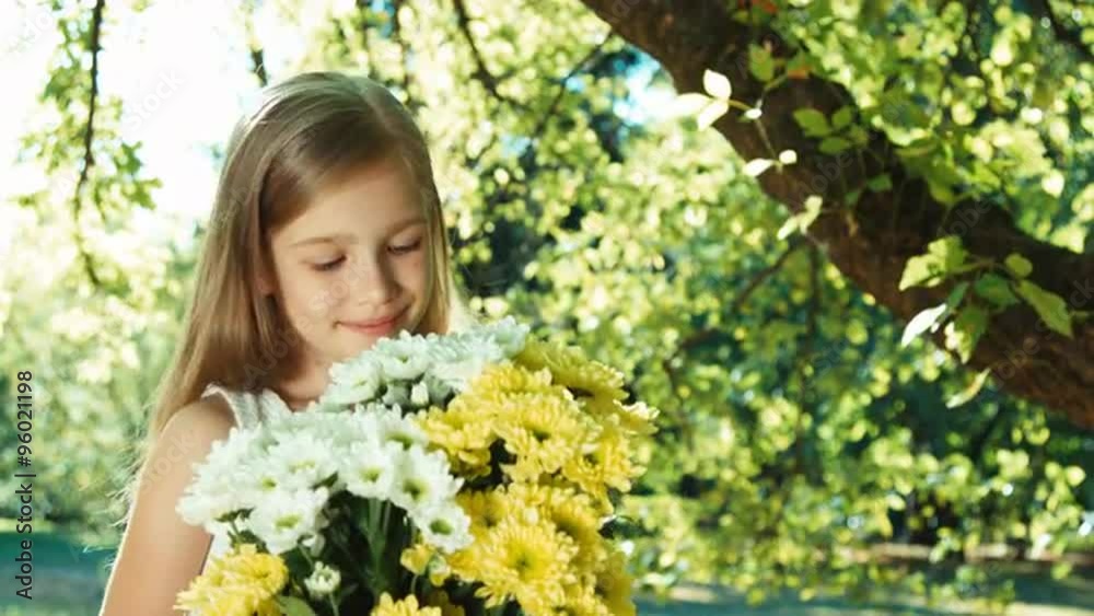 Girl showing bouquet of white and yellow flowers and looking at camera Girl showing bouquet of white and yellow flowers and looking at camera