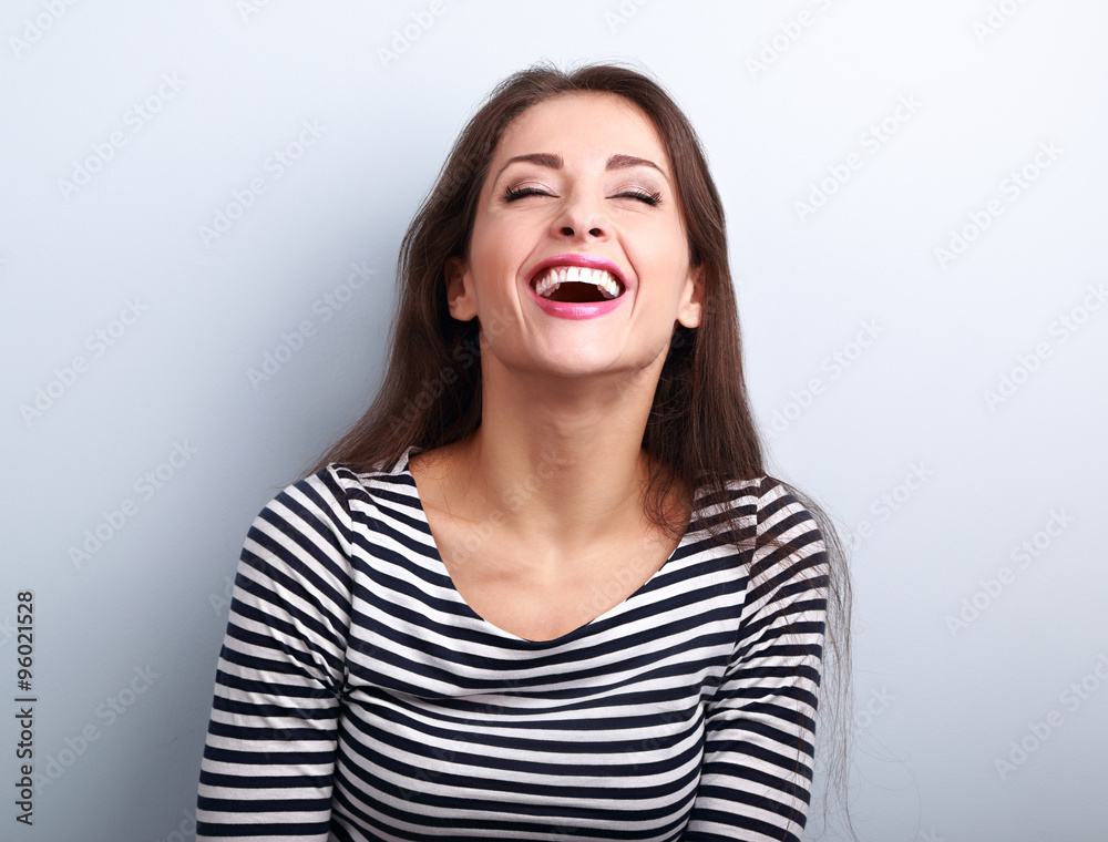 Happy natural laughing young casual woman with wide open mouth a Happy natural laughing young casual woman with wide open mouth a