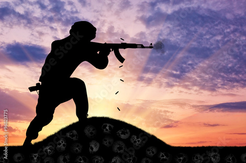 Silhouette of man shooting with rifle against cloudy sky