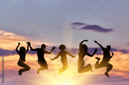  Silhouette of a happy group of people jumping