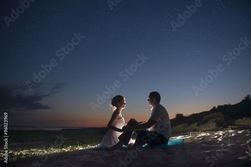 The couple on the seashore at night