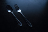 fork and spoon on a black table