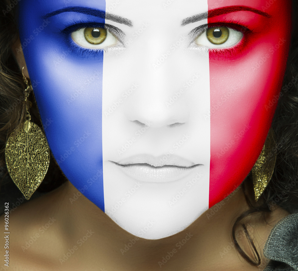 French flag on face of woman with green eyes