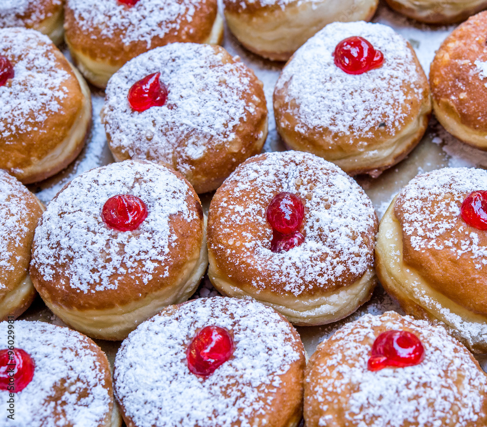 Fresh donuts on the display at bakery for Hanukkah celebration. Fresh donuts on the display at bakery for Hanukkah celebration.