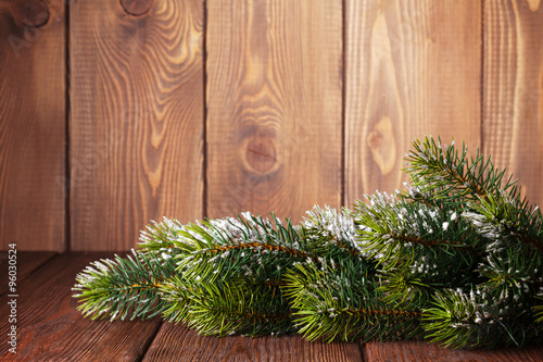 Christmas wooden background with snow fir tree