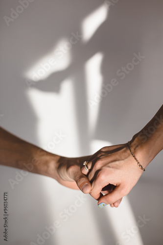 Holding hands shadow on wall