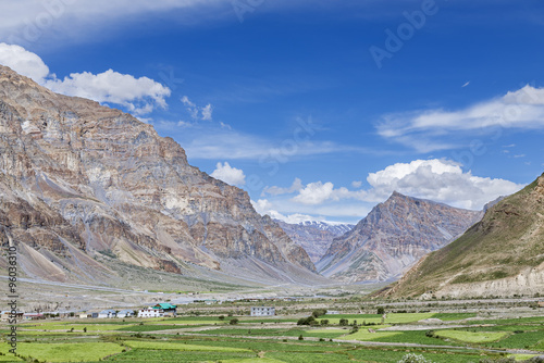 Green fields village among High rocky mountains in Indian Himalaya