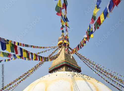 Buddhist stupa Boudnath and colorful prayer flags