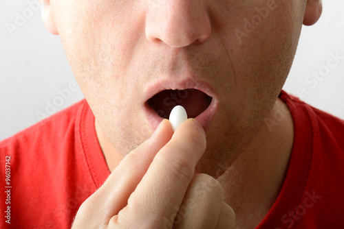 man taking a pill