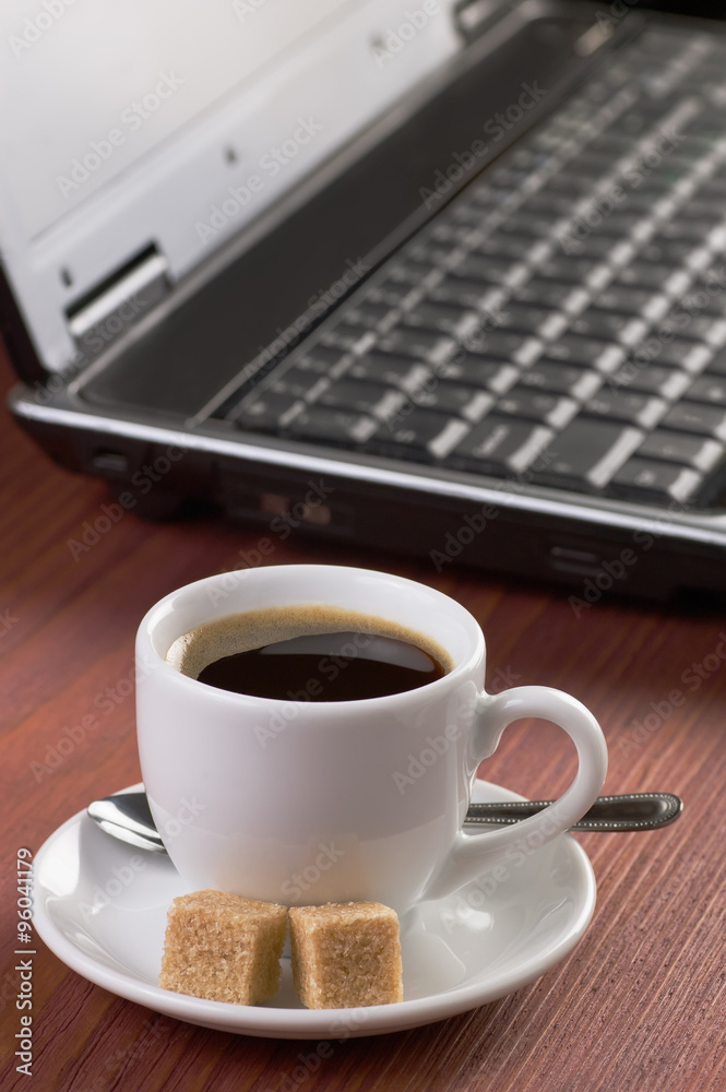Desktop with coffee cup, opened laptop computer, diary and pen on background, no people, focused on coffee Desktop with coffee cup, opened laptop computer, diary and pen on background, no people, focused on coffee