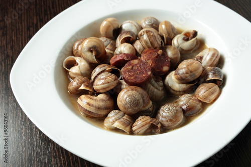 white dish with snails cooked in sauce