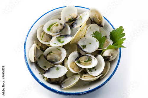 Open clams with parsley on blue napkin, isolated background