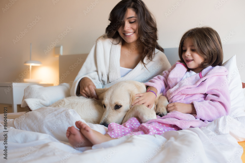 Mother and daughter with dog in bed Mother and daughter with dog in bed