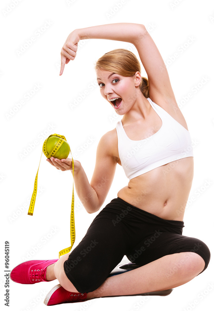 Happy woman holds grapefruit and measurement tape Happy woman holds grapefruit and measurement tape