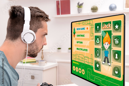 Young man playing computer ...