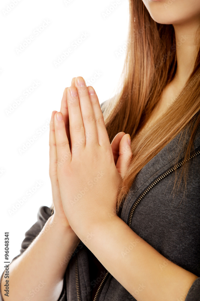Teenage woman praying-religion concept