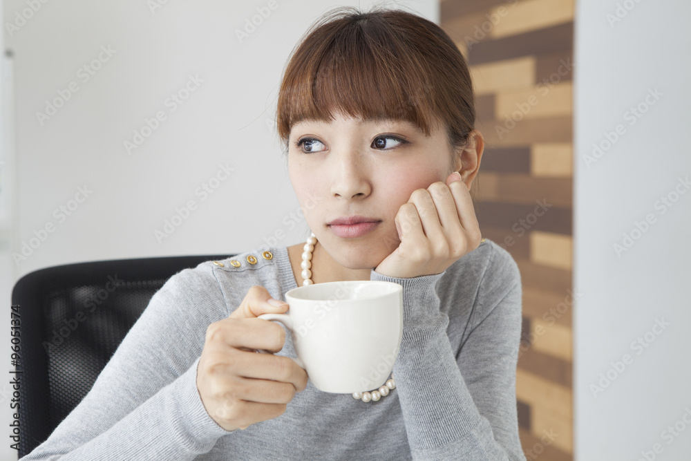 Women drinking coffee at the office Women drinking coffee at the office