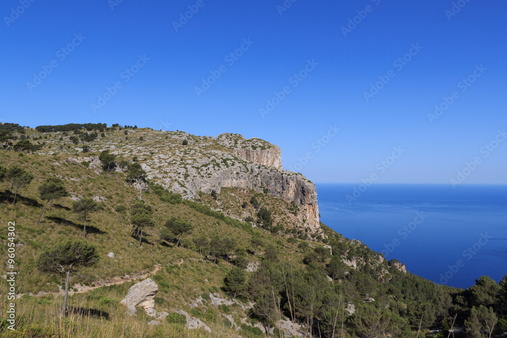 Hiking path in Majorca Tramuntana with Mediterranean Sea in background
