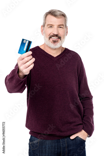 Elderly guy posing stylishly with credit card