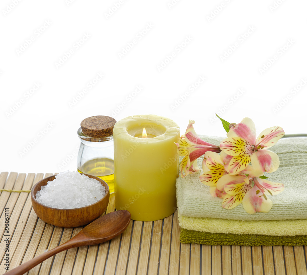 Orchid on towel and spoon,salt in bowl ,towel ,oil, on bamboo mat