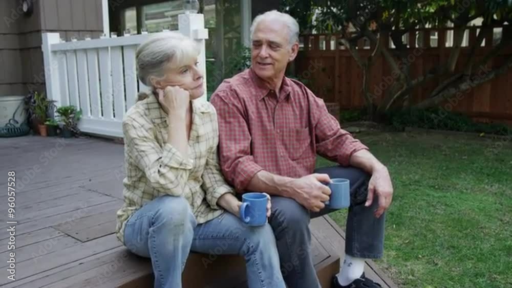 Mature senior couple enjoying a morning cup of coffee outdoors Mature senior couple enjoying a morning cup of coffee outdoors