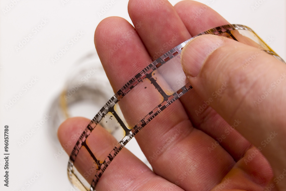 Old film strip in the man's hand