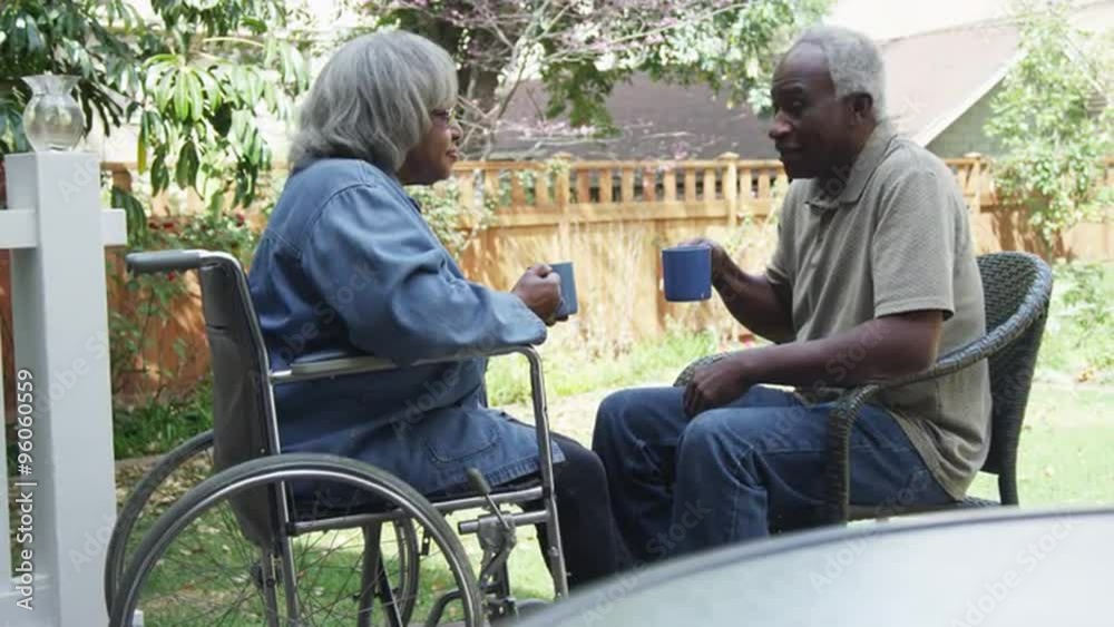 Mature african couple drinking coffee together outdoors Mature african couple drinking coffee together outdoors