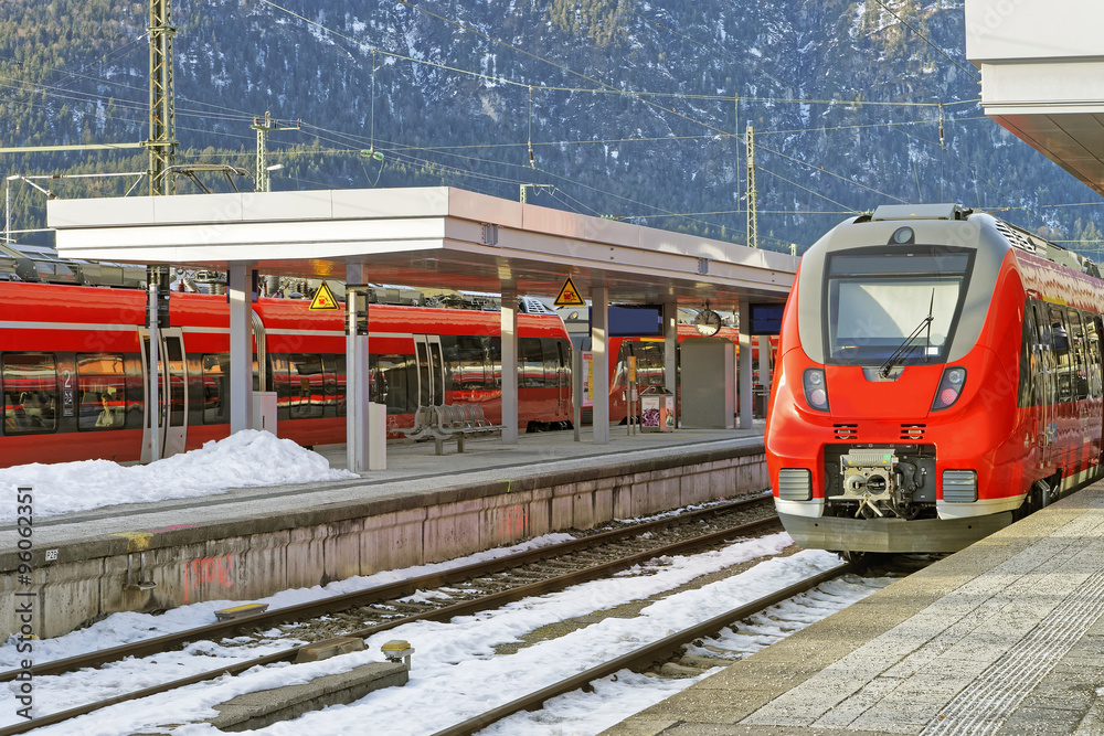 Fototapeta premium Shiny red high-speed train is waiting for passengers