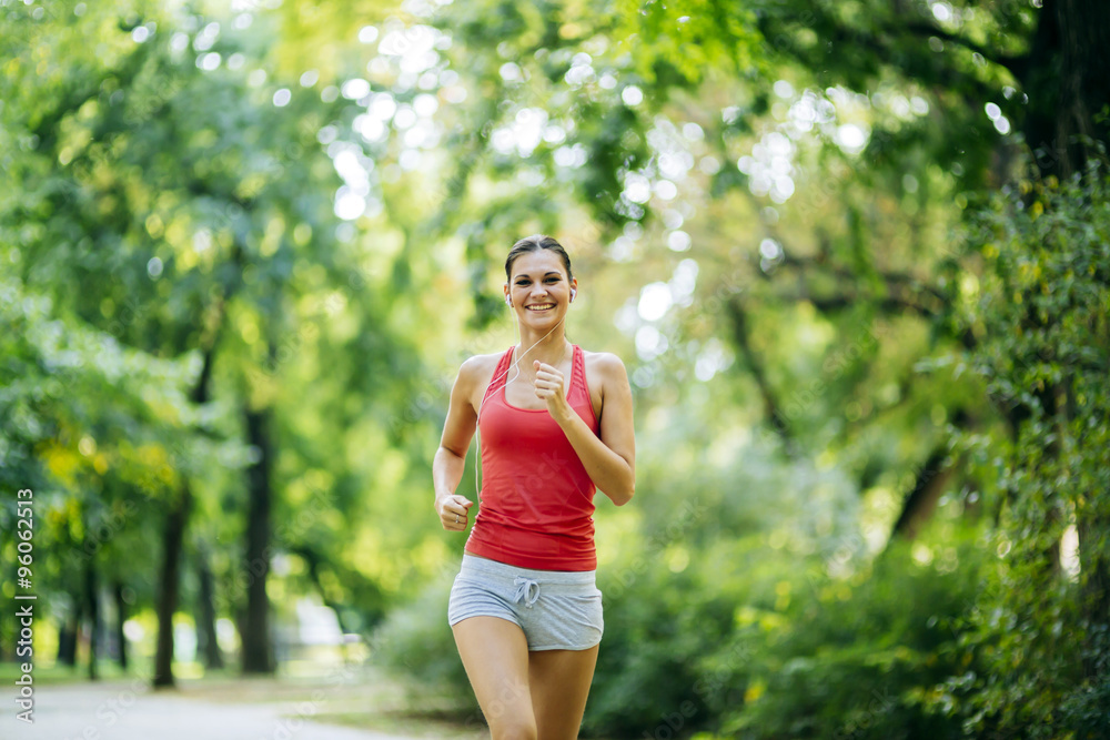 Young beautiful athlete jogging in park Young beautiful athlete jogging in park