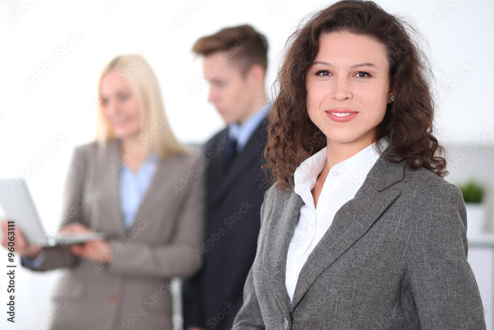 Face of beautiful cheerful smiling business woman on the background of business people Successful business concept