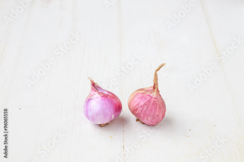 red onions on  wooden background