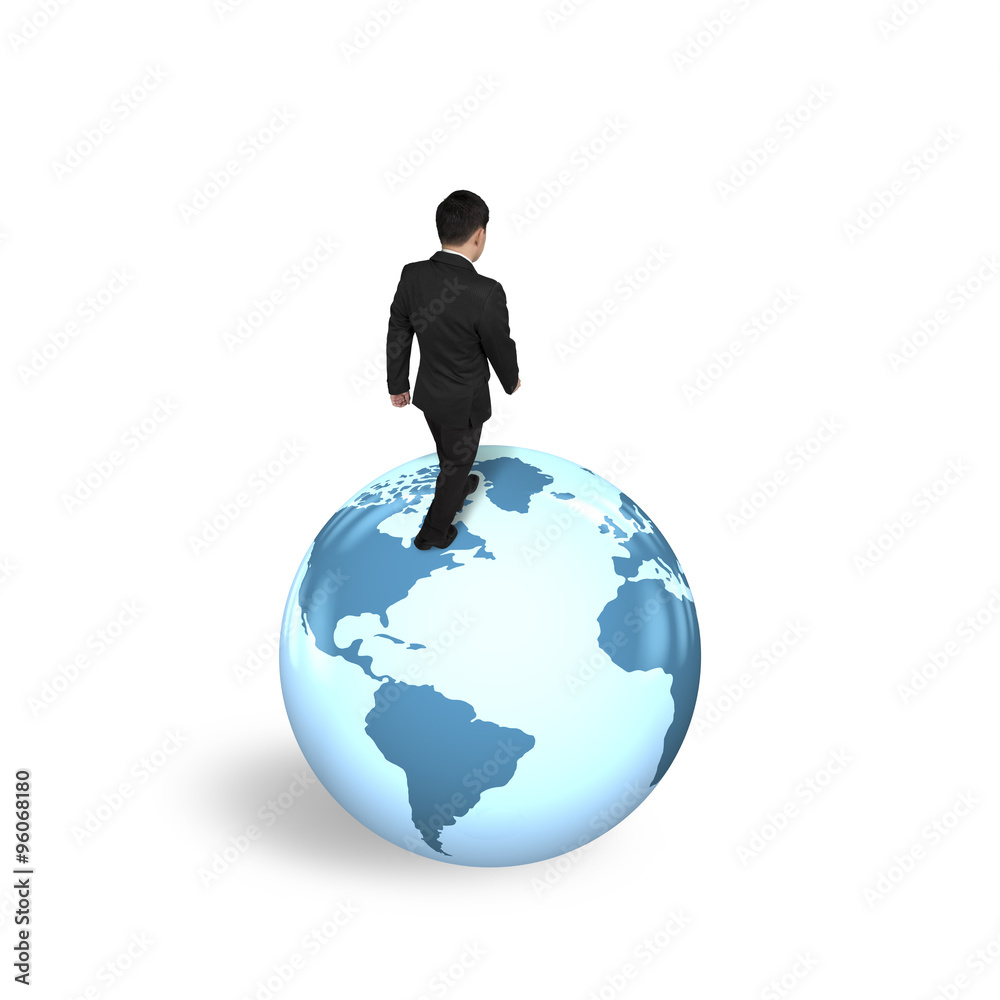 Businessman walking on globe with world map