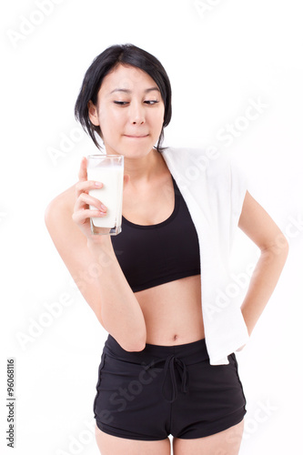 beautiful sport woman holding a glass of milk