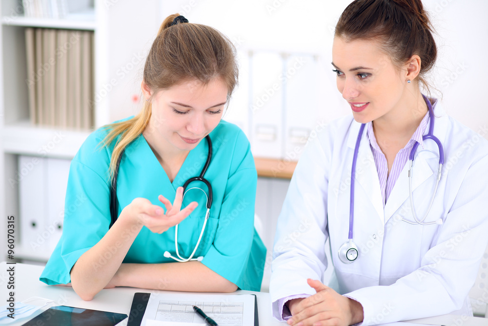 Female doctor and young surgeon intern in hospital Female doctor and young surgeon intern in hospital