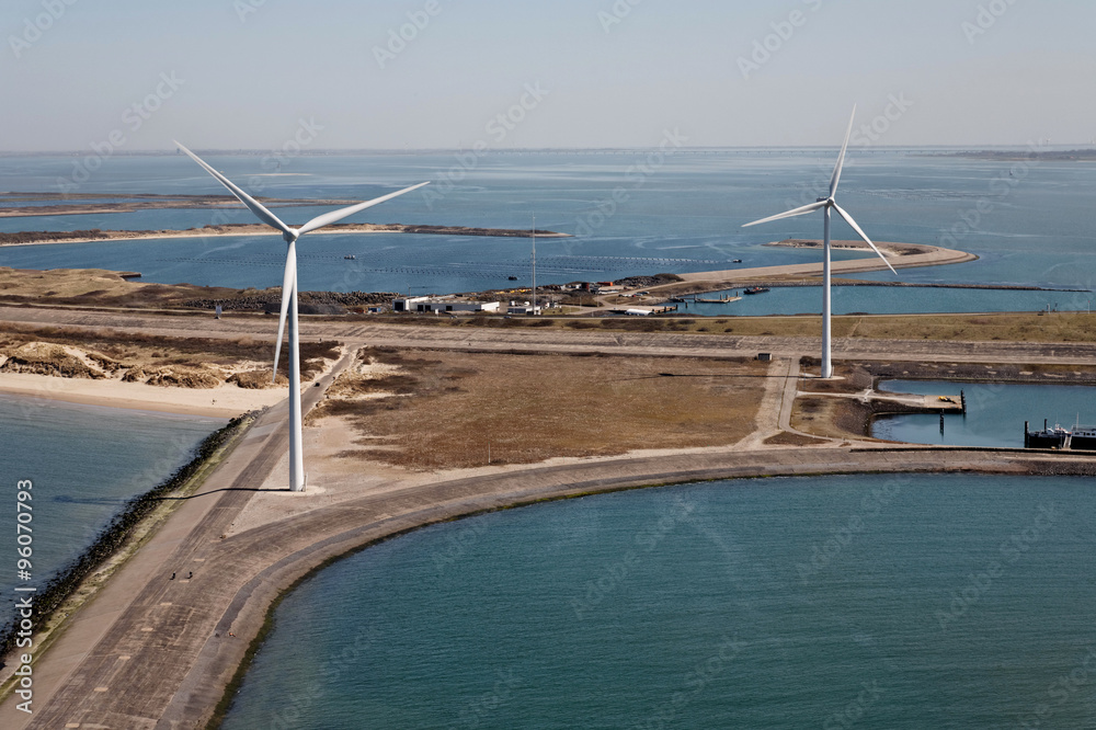 Windmills for renewable electric energy production on an island in the sea