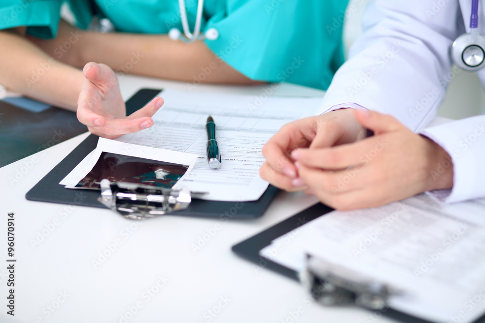 Fototapeta premium Female doctor and young surgeon intern in hospital