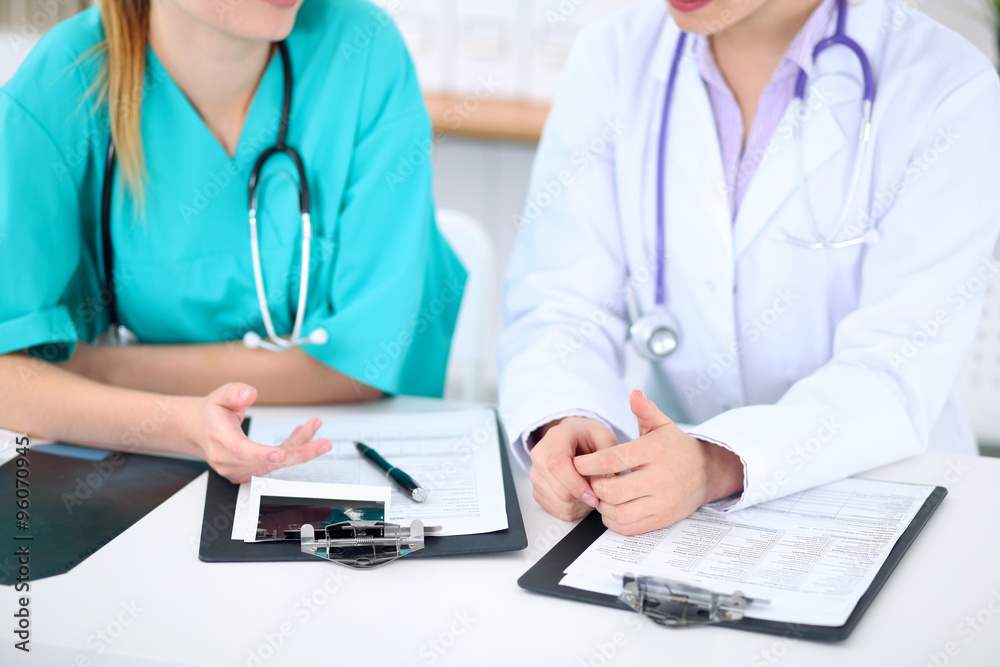 Female doctor and young surgeon intern in hospital Female doctor and young surgeon intern in hospital