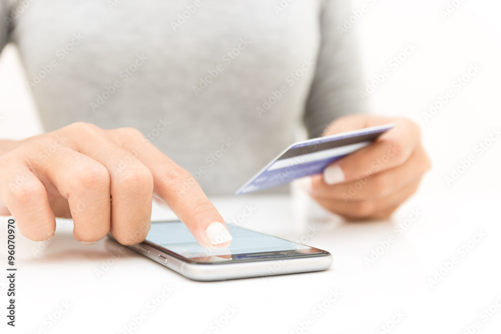closeup woman hand using phone and credit card shopping online closeup woman hand using phone and credit card shopping online
