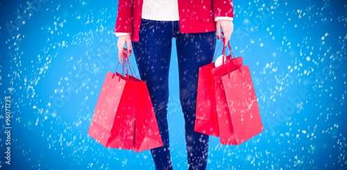 Woman in winter clothes holding shopping bags